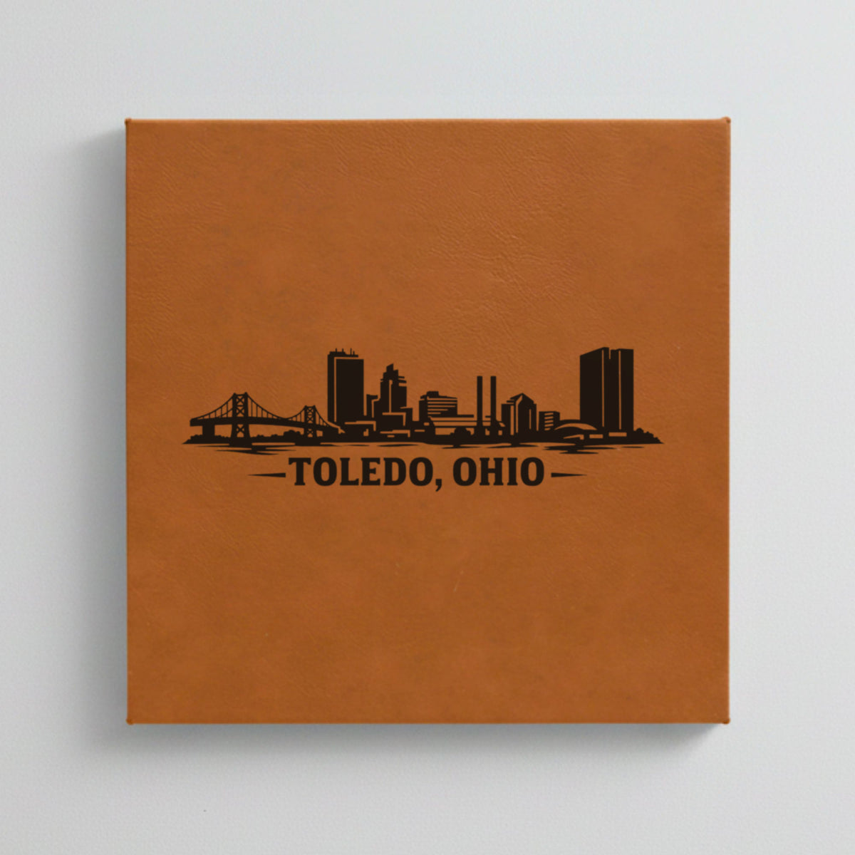 Close up of the Toledo, Ohio skyline engraved on Brown leatherette