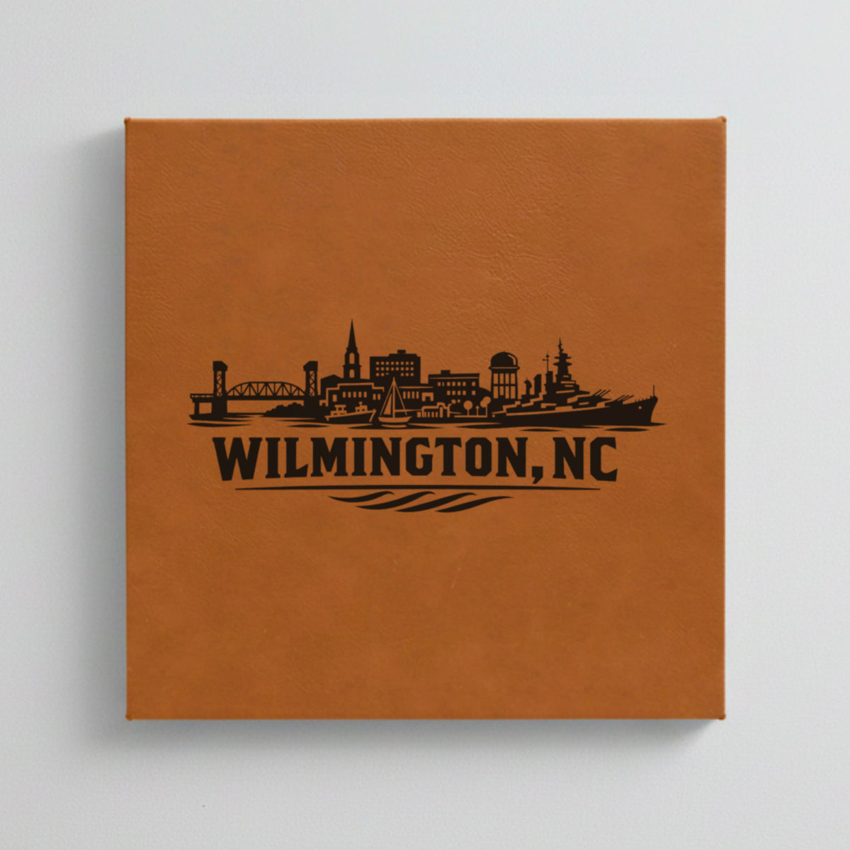 Close up of the Wilmington, North Carolina skyline engraved on Brown leatherette