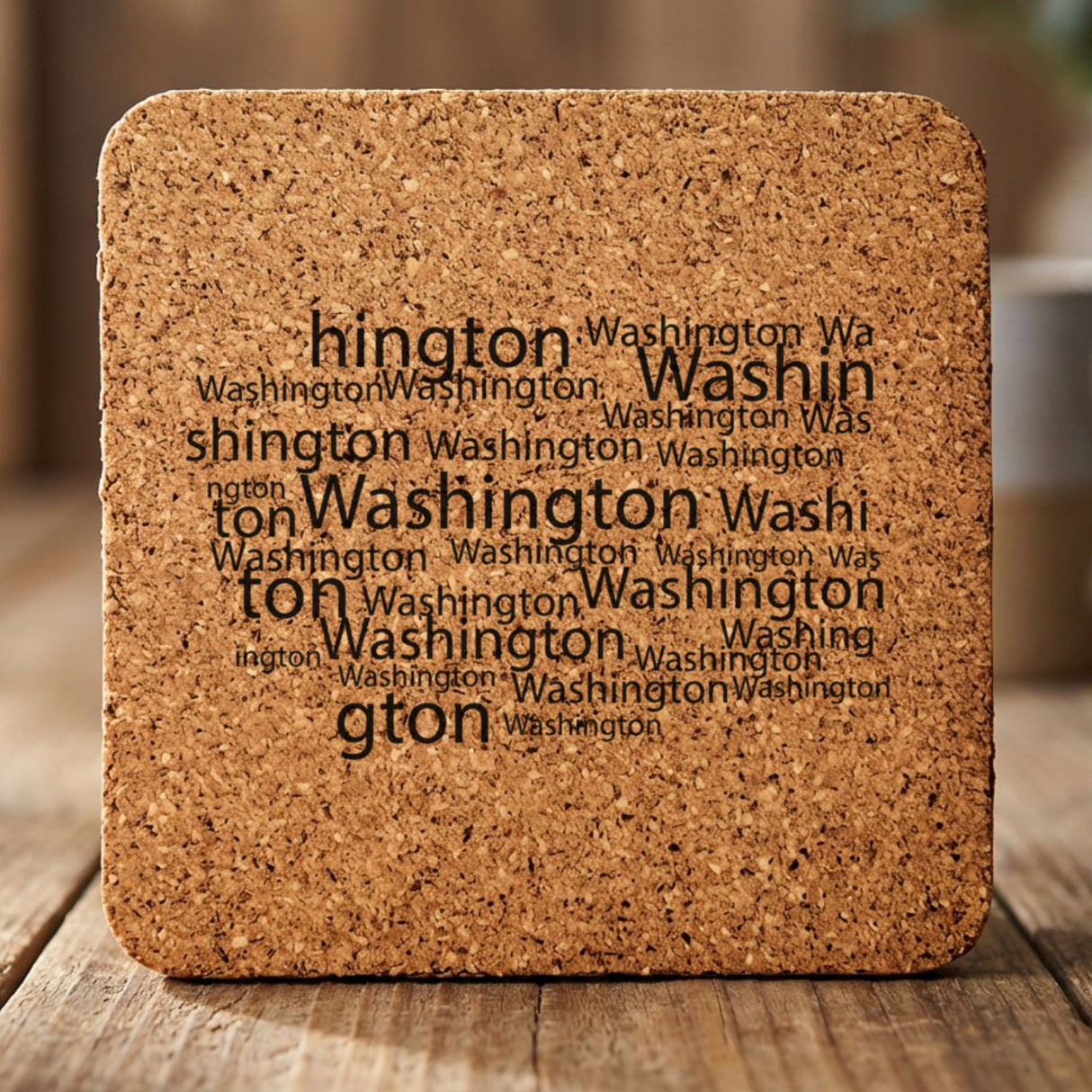 Washington square cork coaster engraved with a word cloud of repeating Washington text