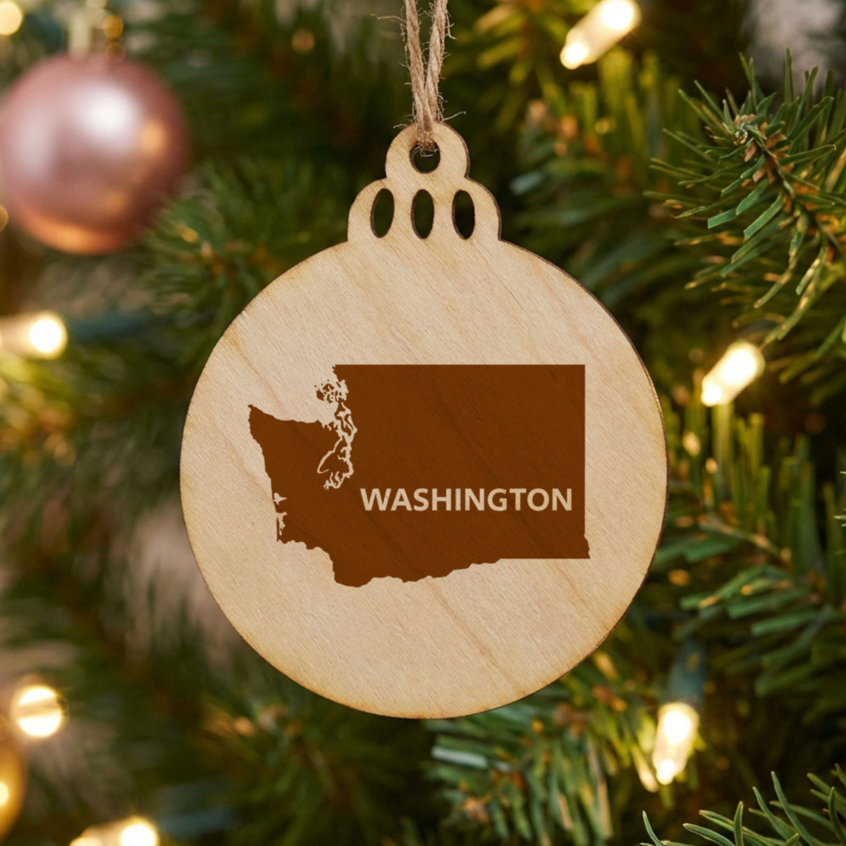 Washington round wood Christmas ornament engraved with the state shape and WASHINGTON in bold lettering