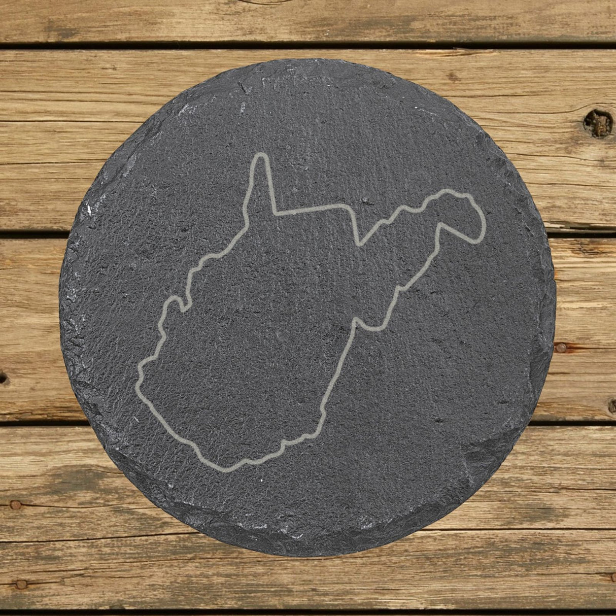 West Virginia round slate coaster engraved with a clean state outline