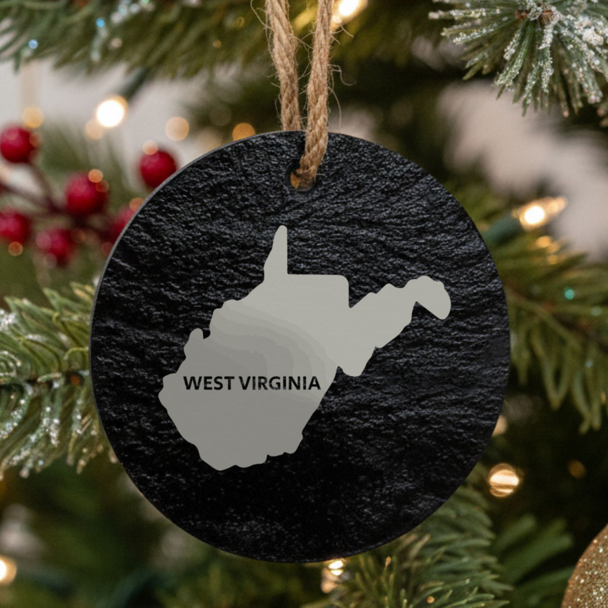 West Virginia round slate Christmas ornament engraved with the state shape and WEST VIRGINIA in bold lettering