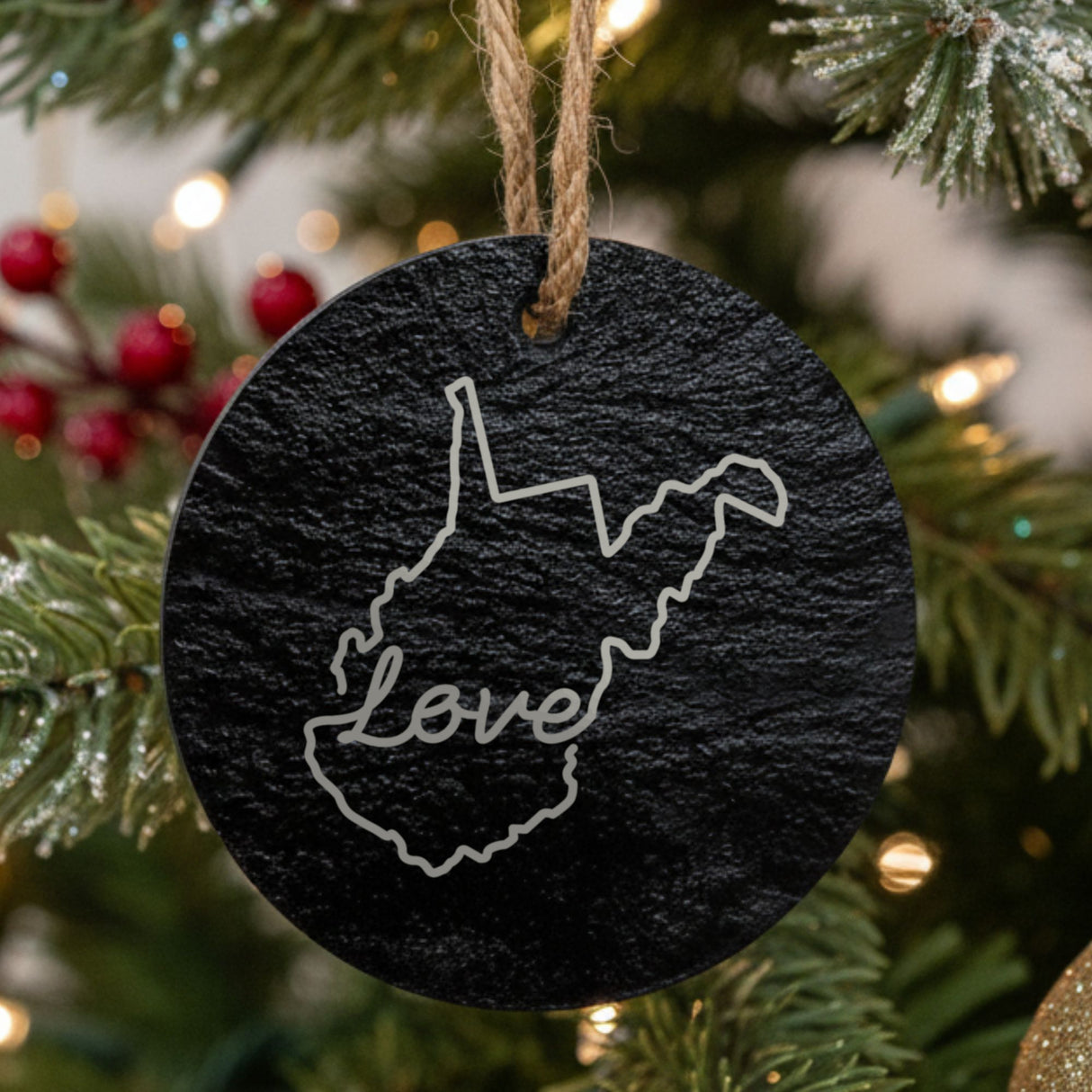West Virginia round slate Christmas ornament engraved with a hand-drawn state outline and love in cursive