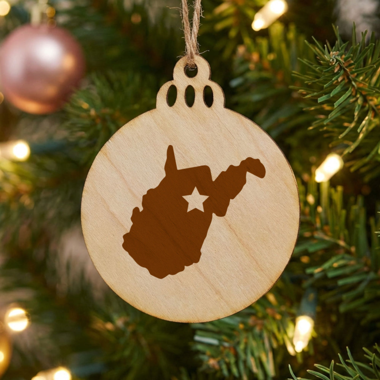 West Virginia round wood Christmas ornament engraved with the state shape and a star