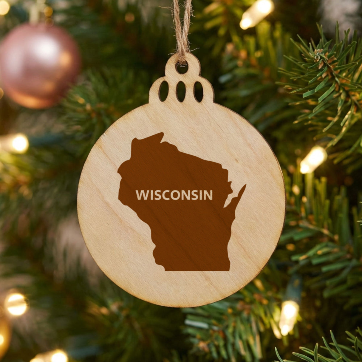 Wisconsin round wood Christmas ornament engraved with the state shape and WISCONSIN in bold lettering