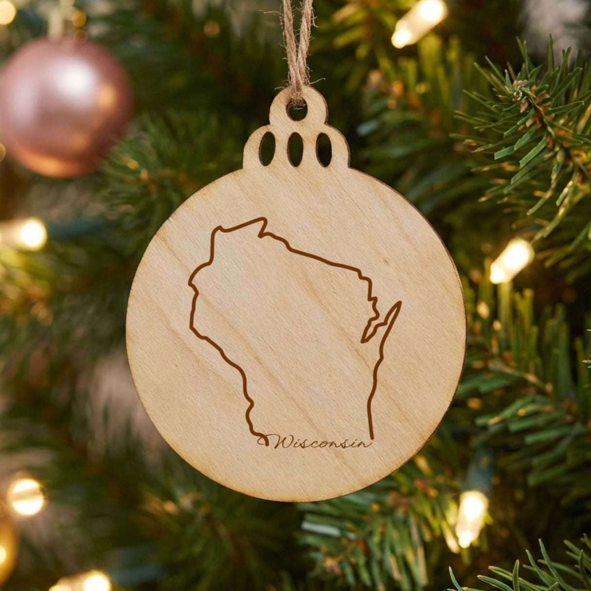 Wisconsin round wood Christmas ornament engraved with the state outline and Wisconsin in script lettering
