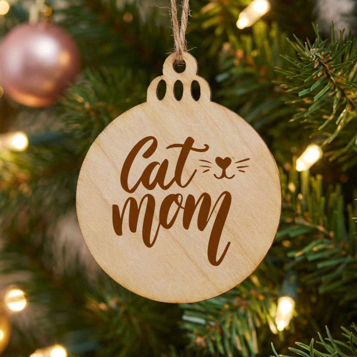 Round wood Christmas ornament laser engraved with "Cat Mom", whiskers design