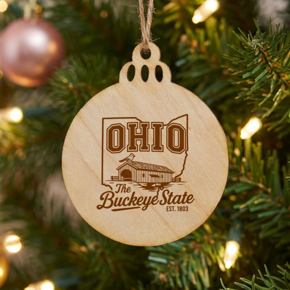 Round wood Christmas ornament laser engraved with an Ohio design of a covered bridge and a cardinal