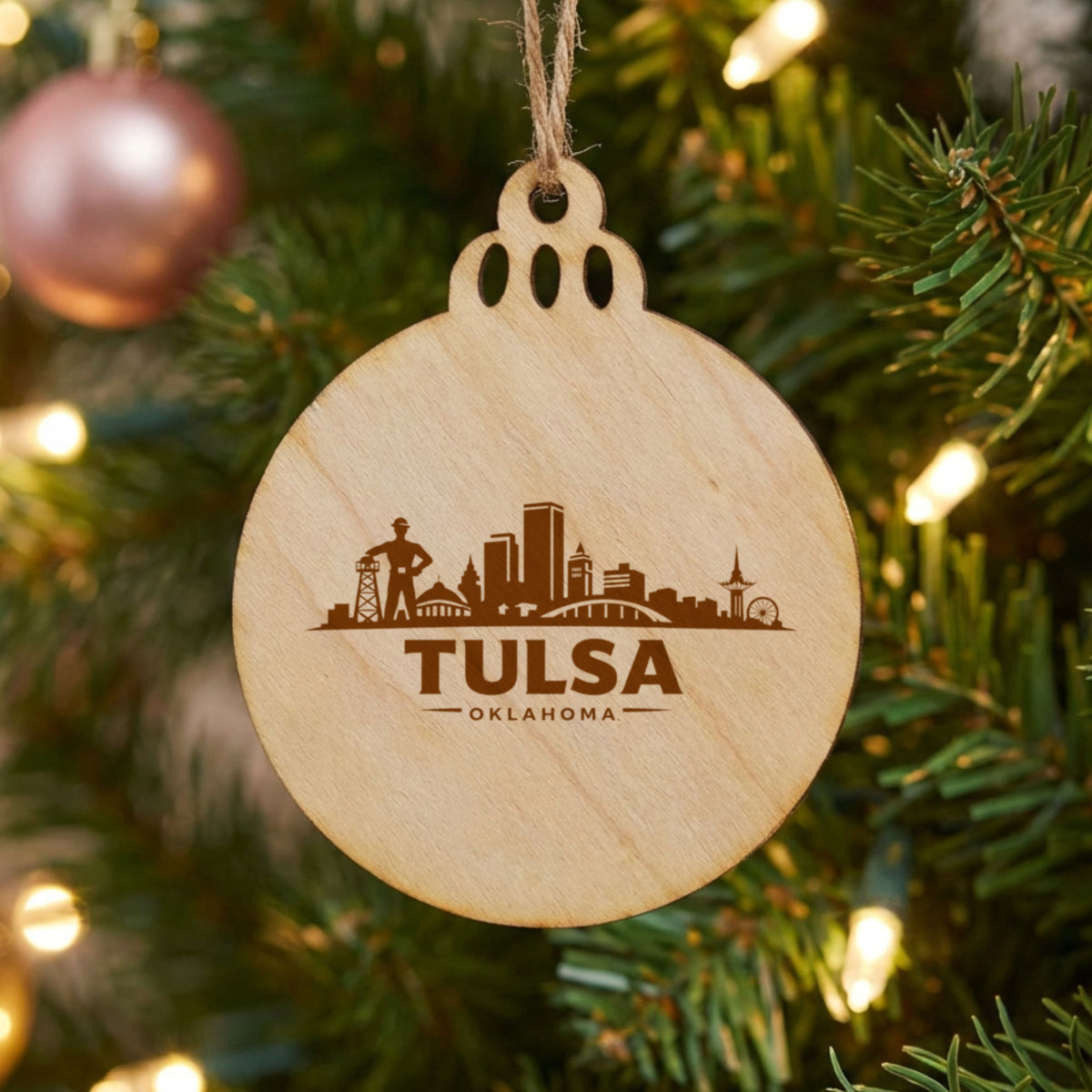 Tulsa, Oklahoma skyline engraved on a round wood Christmas ornament