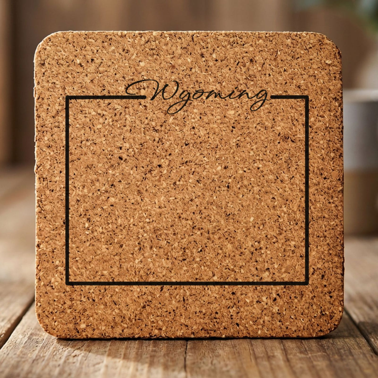 Wyoming square cork coaster engraved with the state outline and Wyoming in script lettering