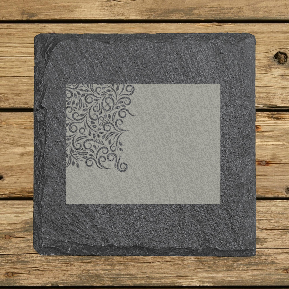 Wyoming square slate coaster engraved with the state shape in ornate floral scrollwork