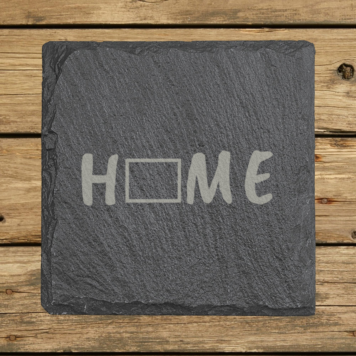 Wyoming square slate coaster engraved with HOME using the state outline as the letter O