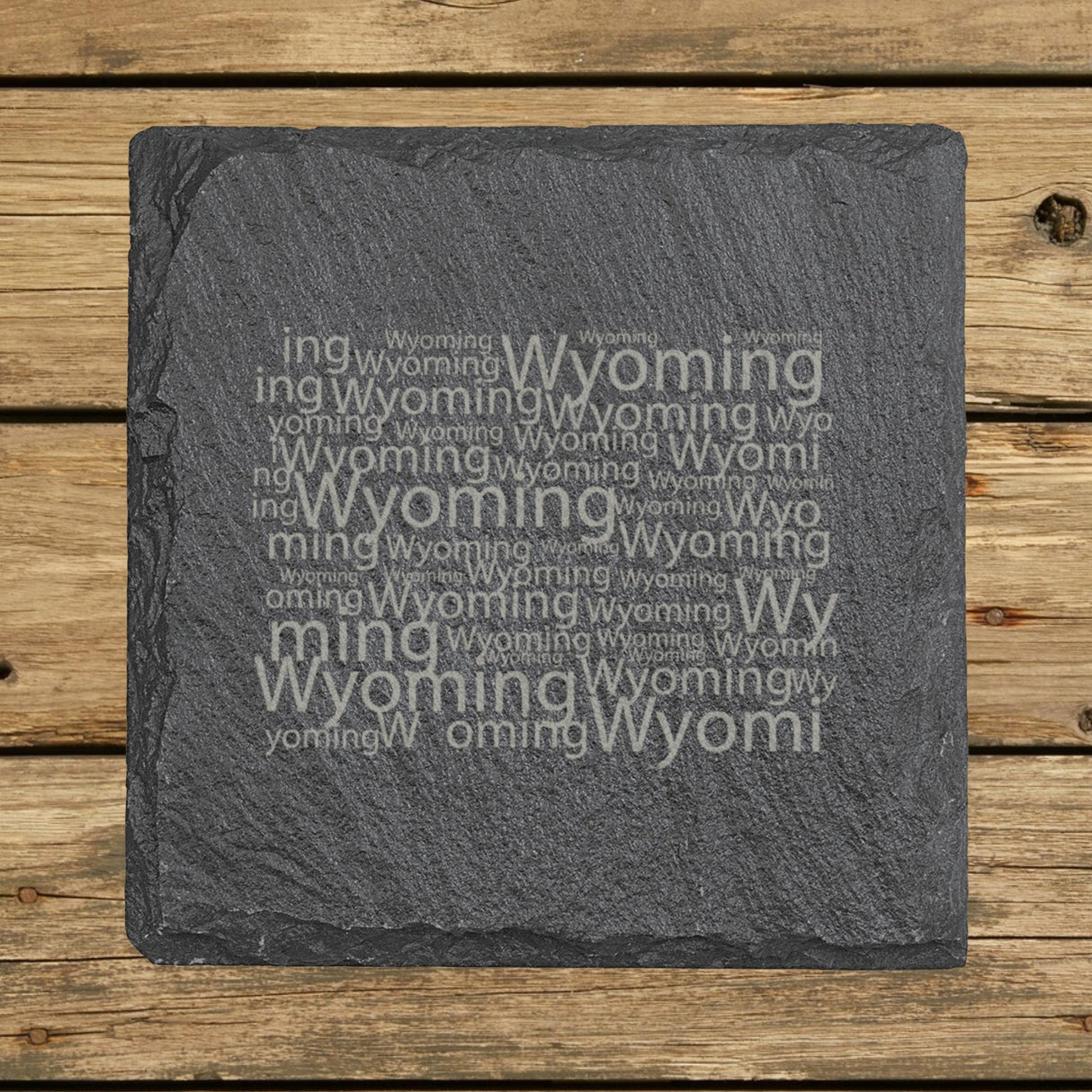 Wyoming square slate coaster engraved with a word cloud of repeating Wyoming text