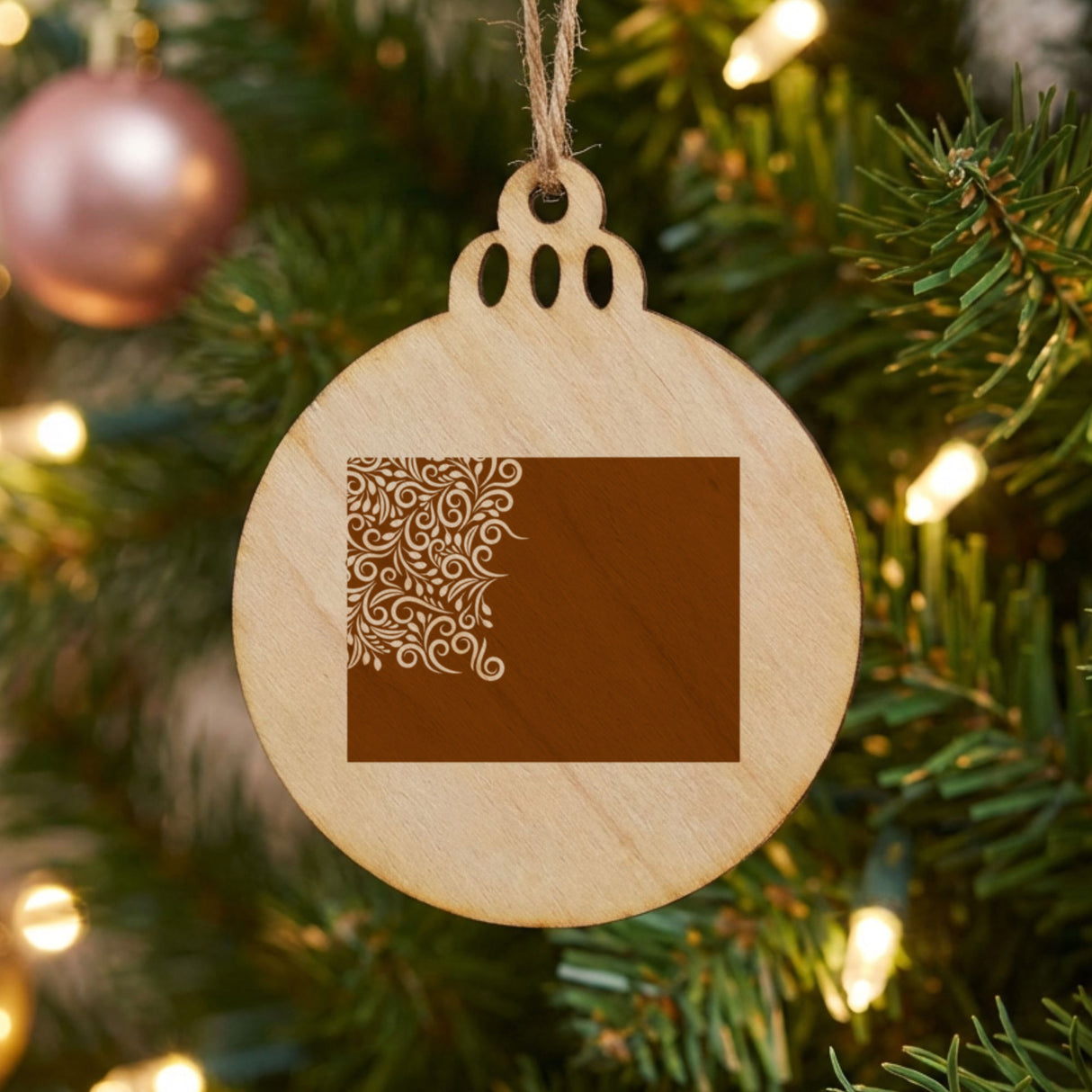 Wyoming round wood Christmas ornament engraved with the state shape in ornate floral scrollwork