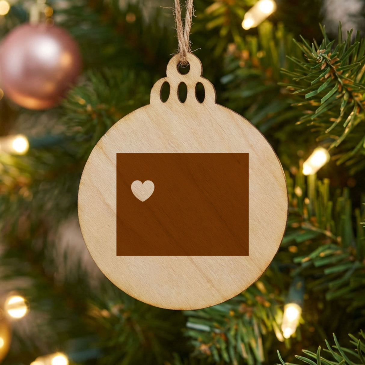 Wyoming round wood Christmas ornament engraved with the state shape and a heart