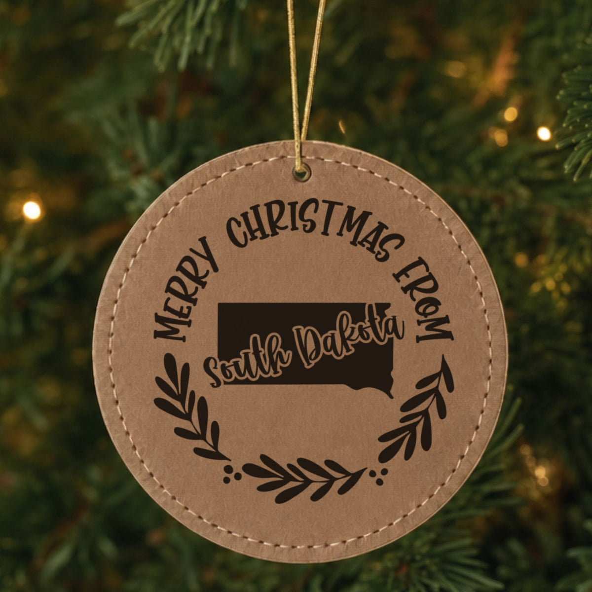 Brown leatherette Christmas ornament engraved Merry Christmas From South Dakota over the state shape