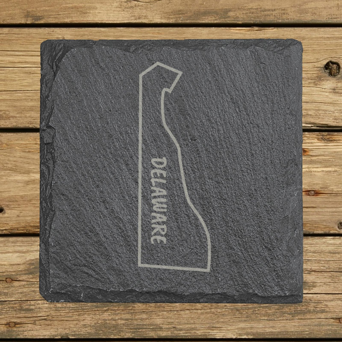 Delaware square slate coaster engraved with the state outline and DELAWARE running vertically