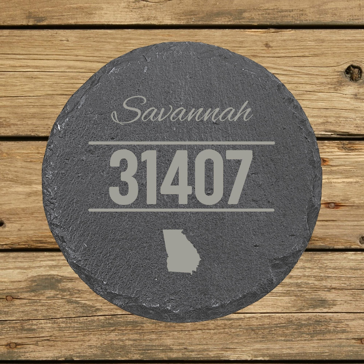 Round slate coaster laser engraved with a custom zip code design