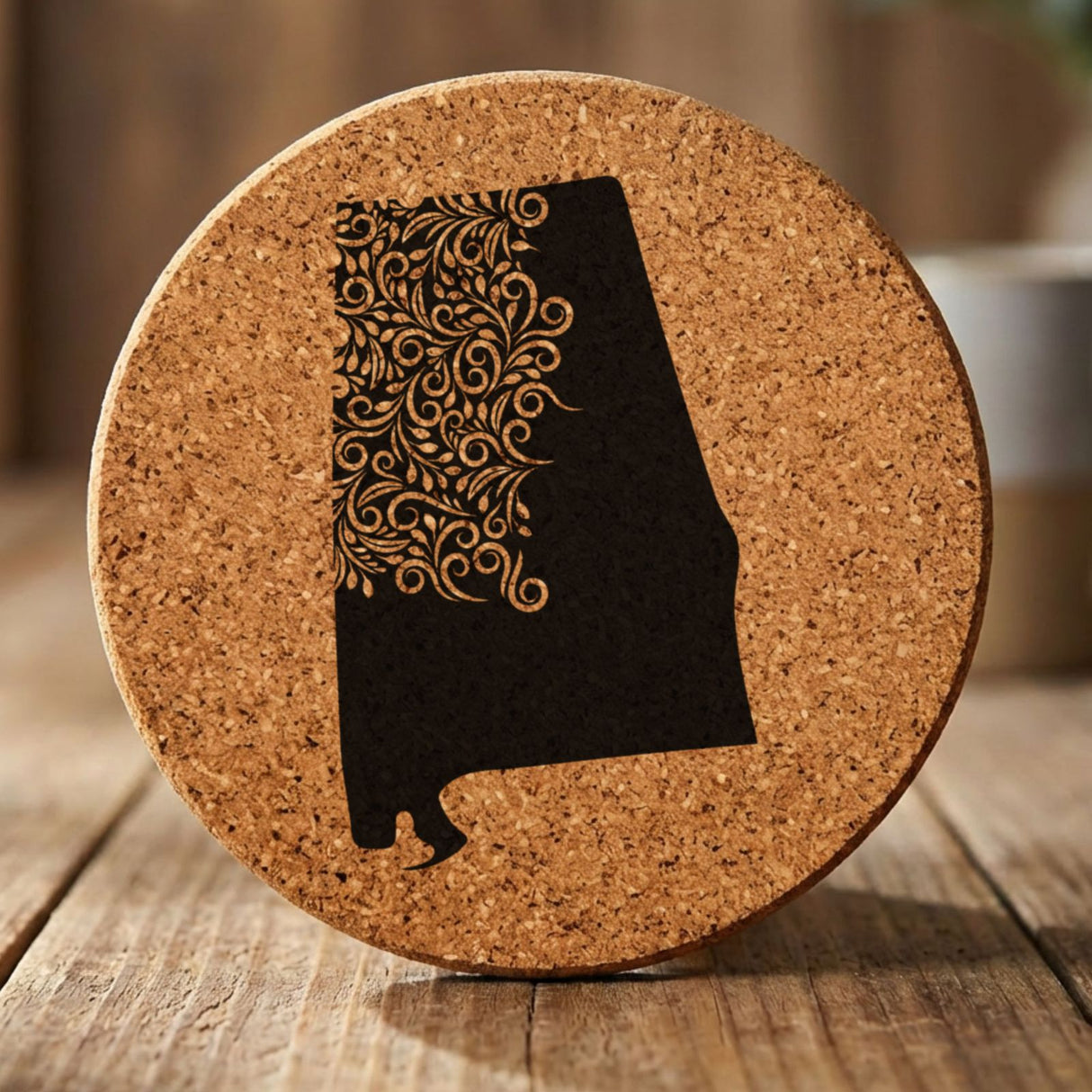 Alabama round cork coaster engraved with the state shape in ornate floral scrollwork