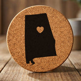 Alabama round cork coaster engraved with the state shape and a heart