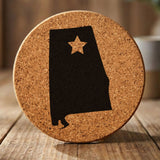 Alabama round cork coaster engraved with the state shape and a star