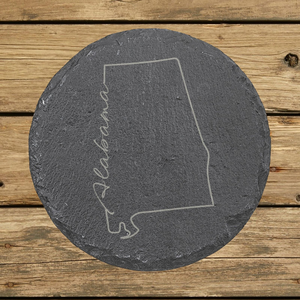 Alabama round slate coaster engraved with the state outline and Alabama in script lettering