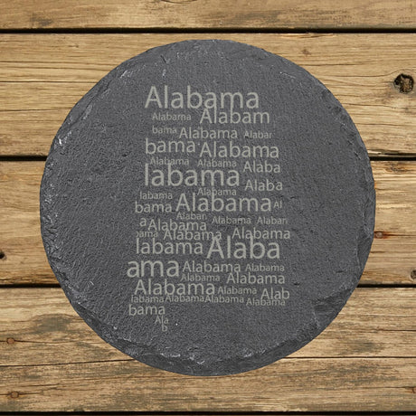 Alabama round slate coaster engraved with a word cloud of repeating Alabama text