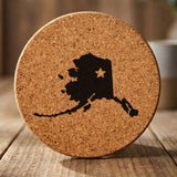 Alaska round cork coaster engraved with the state shape and a star