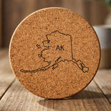 Alaska round cork coaster engraved with the state outline and AK initials