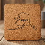 Alaska square cork coaster engraved with the state outline and ALASKA in hand-drawn brush lettering