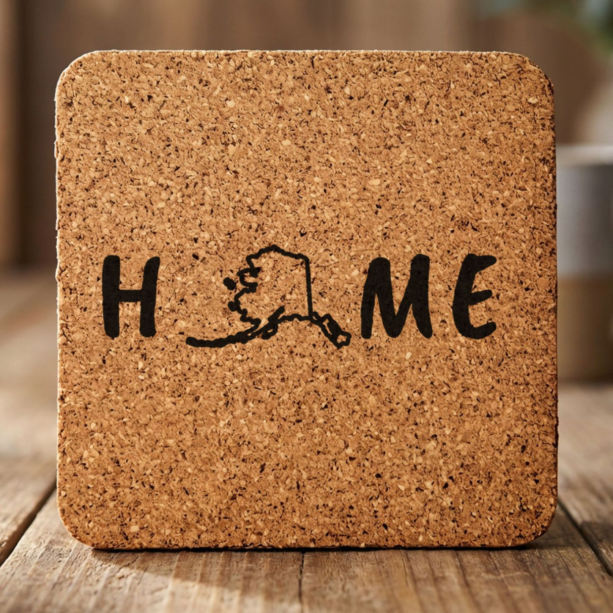 Alaska square cork coaster engraved with HOME using the state outline as the letter O