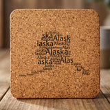 Alaska square cork coaster engraved with a word cloud of repeating Alaska text