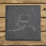 Alaska square slate coaster engraved with the state outline and ALASKA in hand-drawn brush lettering