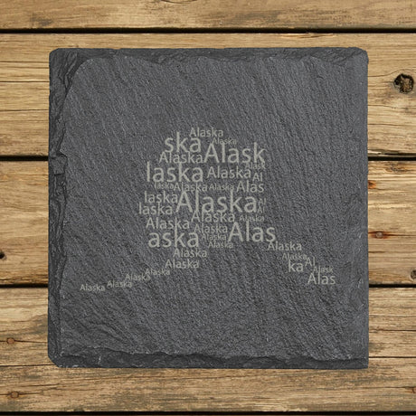 Alaska square slate coaster engraved with a word cloud of repeating Alaska text