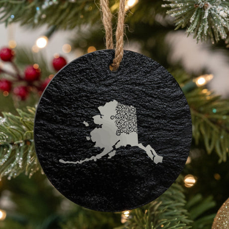 Alaska round slate Christmas ornament engraved with the state shape in ornate floral scrollwork
