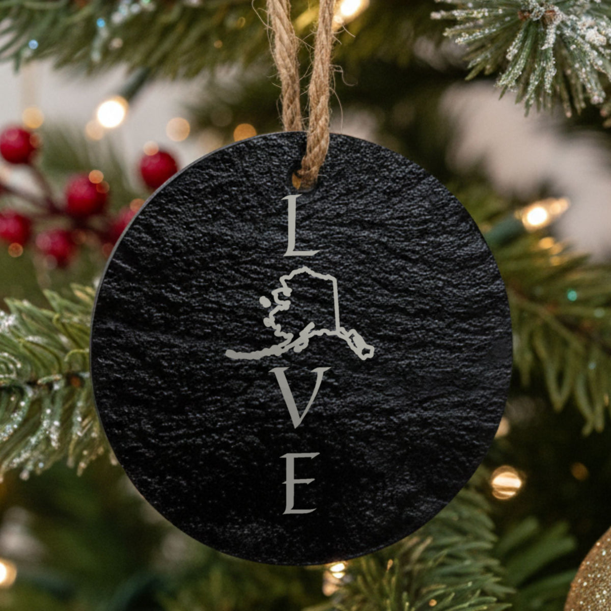 Alaska round slate Christmas ornament engraved with LOVE stacked vertically using the state as the letter O