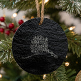 Alaska round slate Christmas ornament engraved with a word cloud of repeating Alaska text