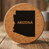 Arizona round cork coaster engraved with the state shape and ARIZONA in bold lettering