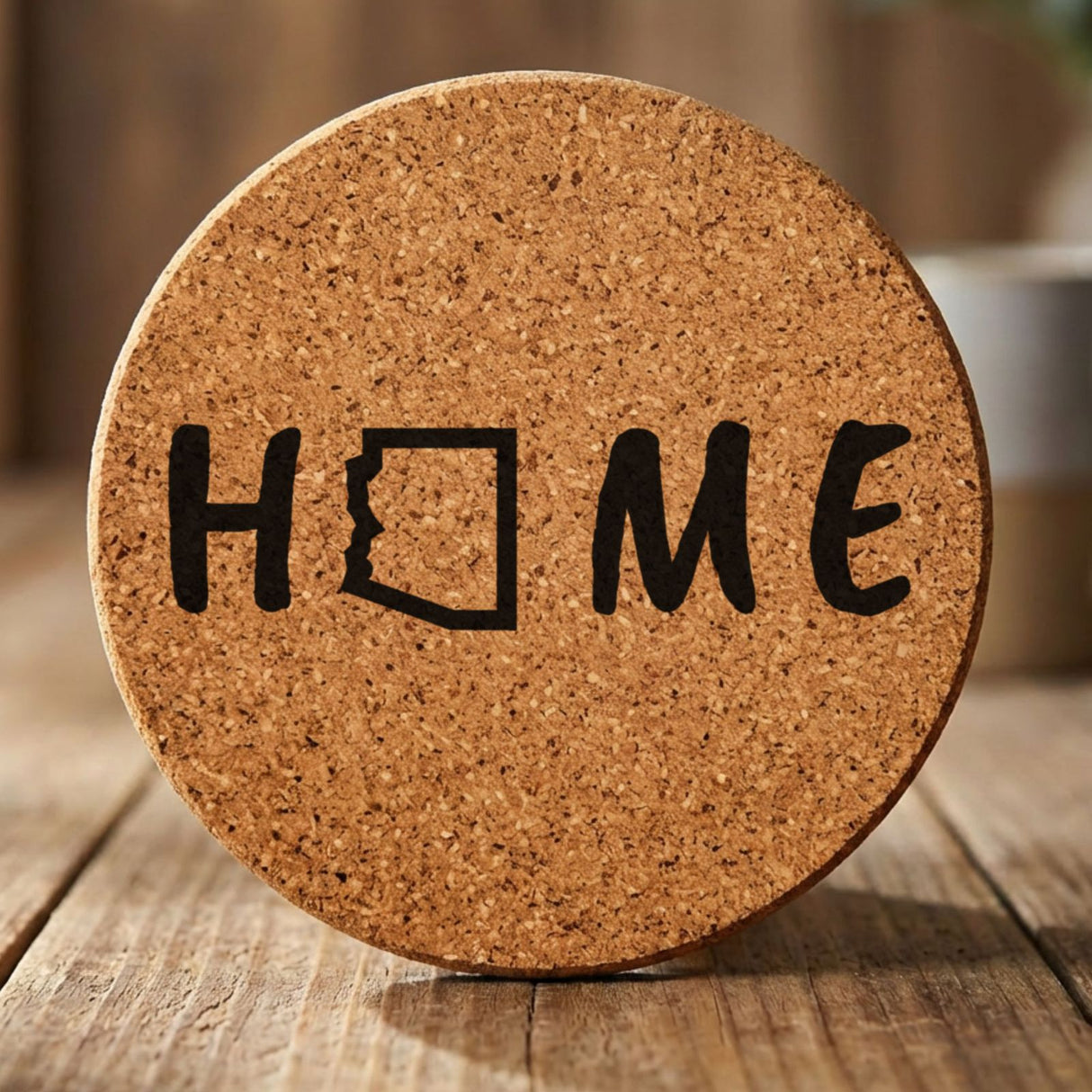 Arizona round cork coaster engraved with HOME using the state outline as the letter O