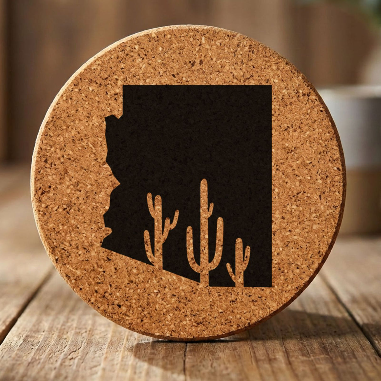 Arizona round cork coaster engraved with the state shape and saguaro cacti