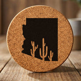 Arizona round cork coaster engraved with the state shape and saguaro cacti