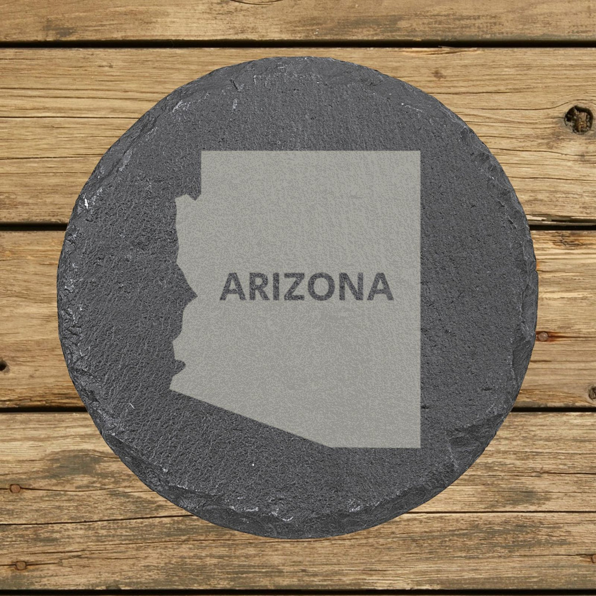 Arizona round slate coaster engraved with the state shape and ARIZONA in bold lettering