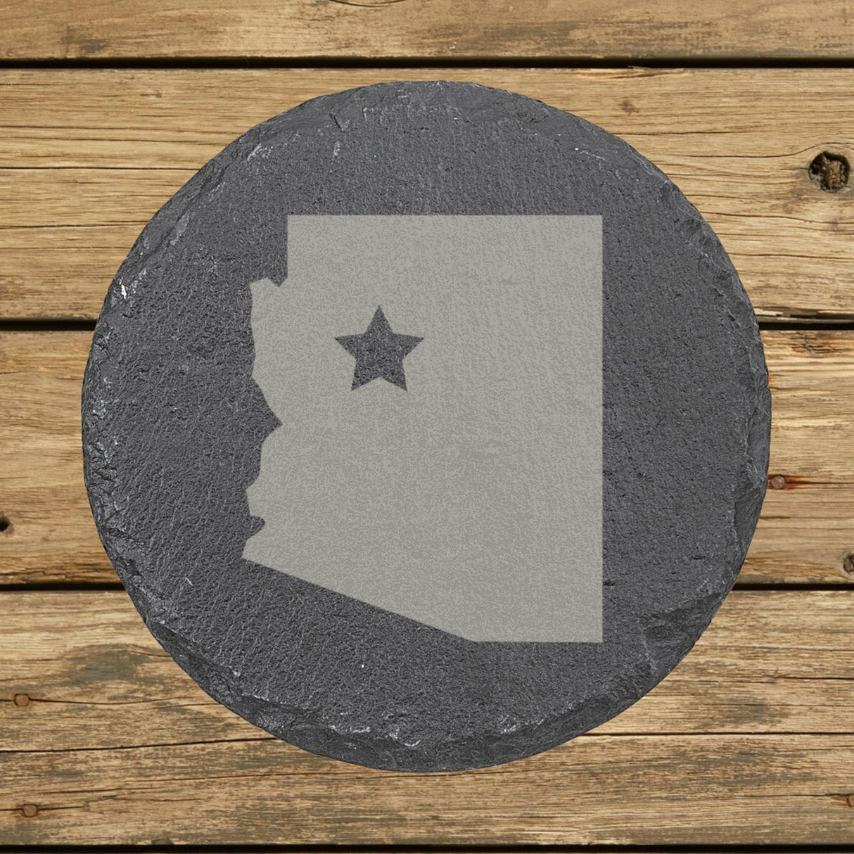 Arizona round slate coaster engraved with the state shape and a star