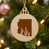 Arizona round wood Christmas ornament engraved with the state outline and a saguaro cactus