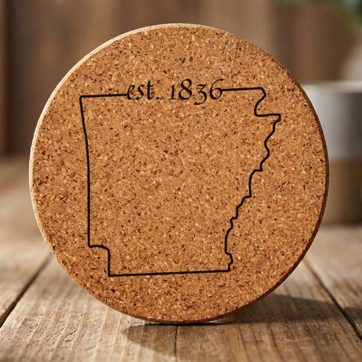 Arkansas round cork coaster engraved with the state outline and est. 1836