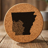 Arkansas round cork coaster engraved with the state shape in ornate floral scrollwork