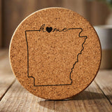 Arkansas round cork coaster engraved with the state outline and home in script with a heart