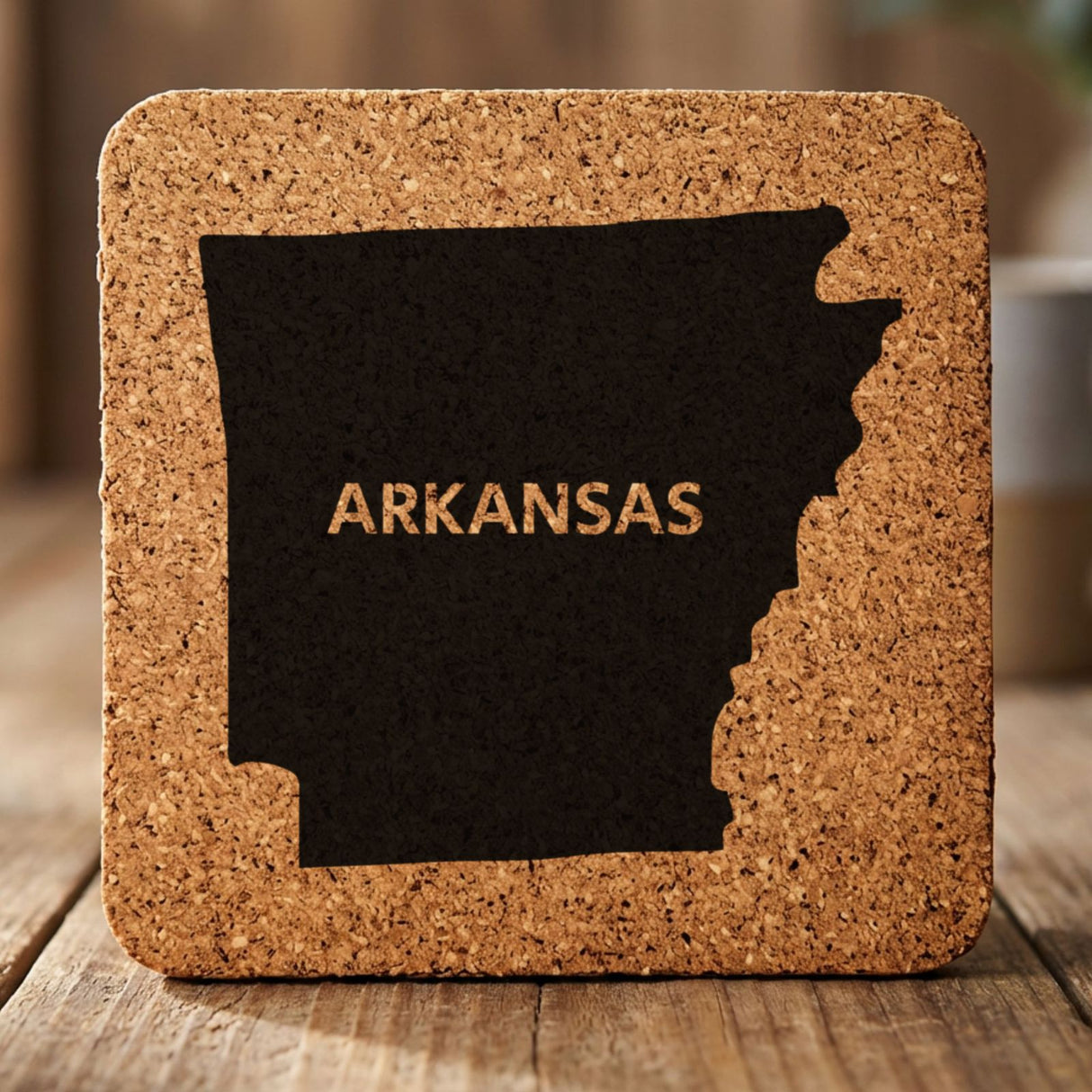 Arkansas square cork coaster engraved with the state shape and ARKANSAS in bold lettering