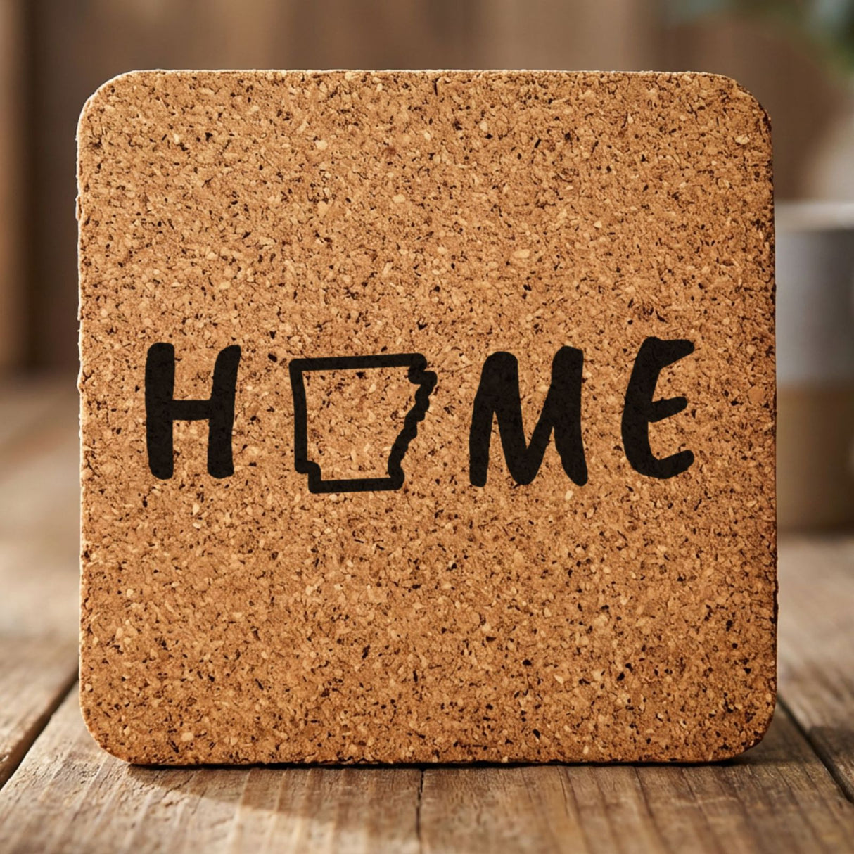 Arkansas square cork coaster engraved with HOME using the state outline as the letter O