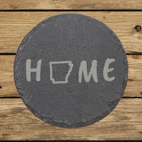 Arkansas round slate coaster engraved with HOME using the state outline as the letter O
